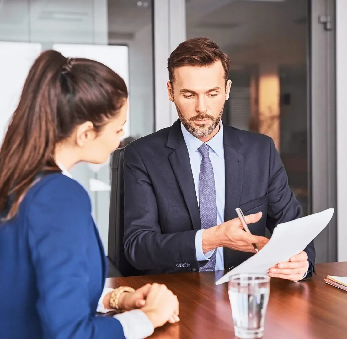 Man reviewing documents with colleague in office